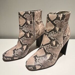 Dolce Vita snakeskin print heeled boots with silver side zipper.